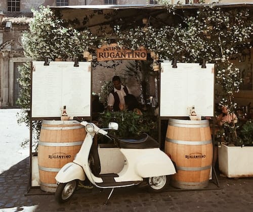 Vespa in front of a restaurant, Italy